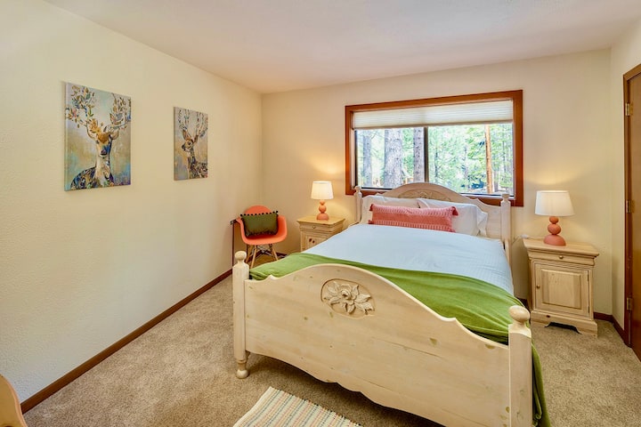 Second main level bedroom with check of drawers and sitting area. 
