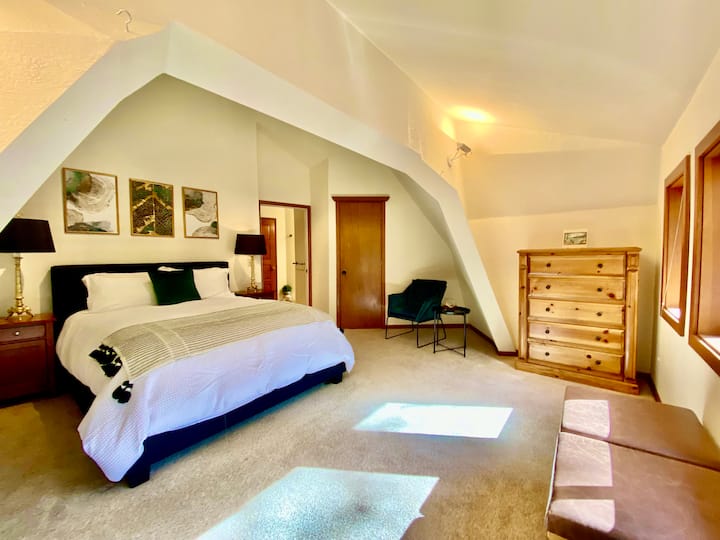 Primary bedroom with sitting area.