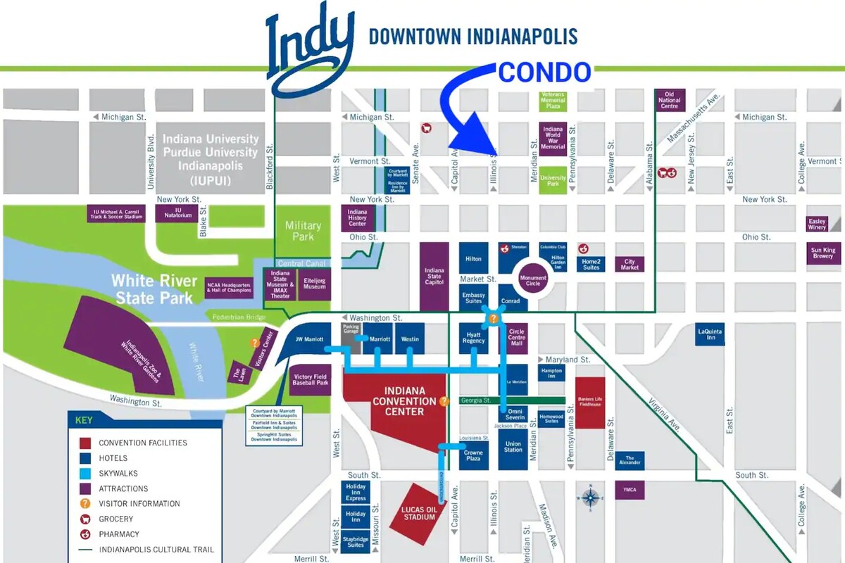 A map of Downtown Indianapolis outlines key locations, including the Indiana Convention Center and nearby attractions. The condo's position is indicated with a blue arrow, showing its proximity to various venues and amenities in the vibrant downtown area.