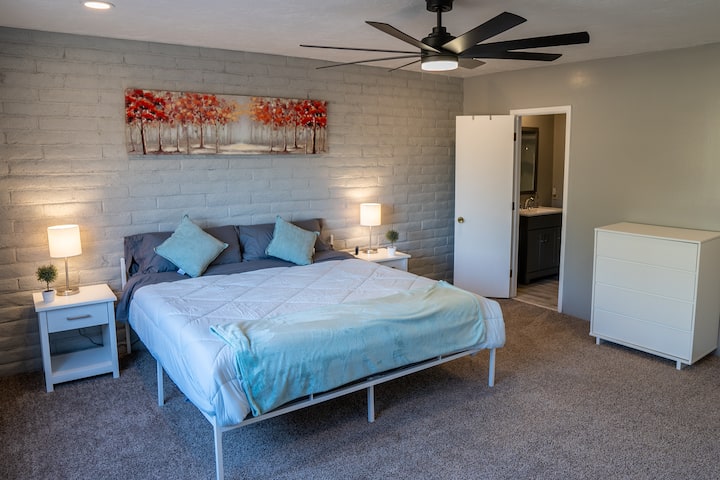 Bedroom 1, with private bathroom. 

Both bedrooms equipped with 60W Anker USB charging station to simultaneously recharge up to 6 personal electronic devices (right hand side of bed in photo). 

Extra charge cords available upon request.
