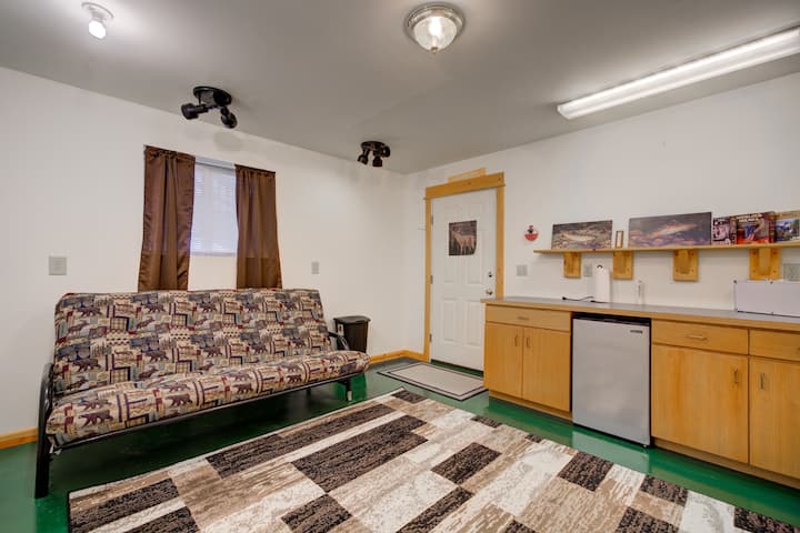 Downstairs activity room with futon and access to back patio/garage 