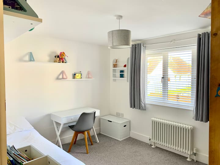 חדר שינה יחיד עם שפע של מקום לשחק או לעבוד. ילד אחר יכול בקלות לעלות על מיטת אוויר על הרצפה.