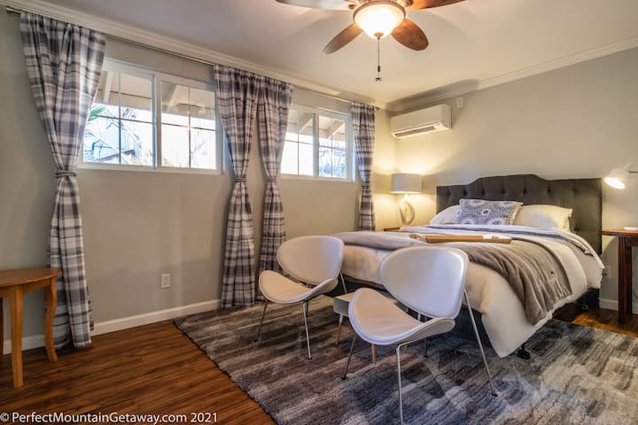 The Hygge (cozy/contended) inspired Queen Bedroom is at the back of the house where it’s nice and quiet and has a luxurious gray and white palette. This room has an en-suite bathroom, which includes a walk in shower and large closet. 