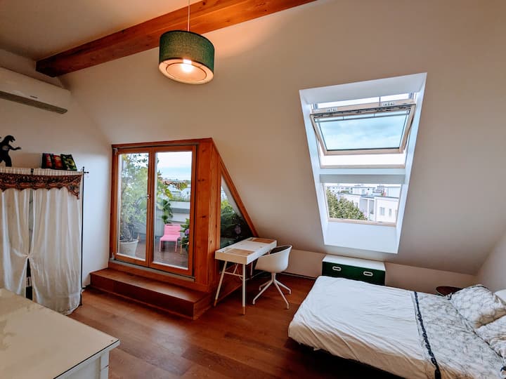 The first bedroom with a dedicated work space opens onto a balcony shared with the second bedroom. 