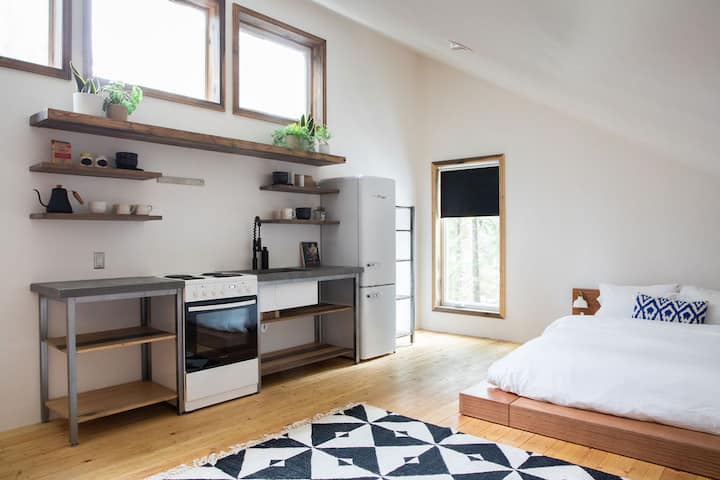 Private garage suite with Queen bed, small sitting area, bathroom and kitchenette. 