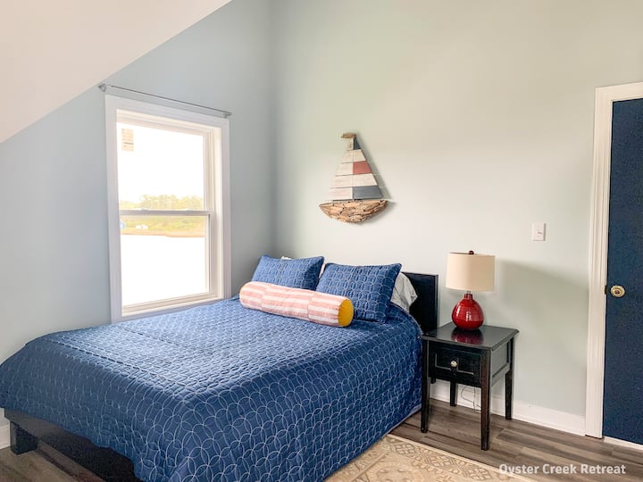 The eastern bedroom has a queen-sized bed and water views.