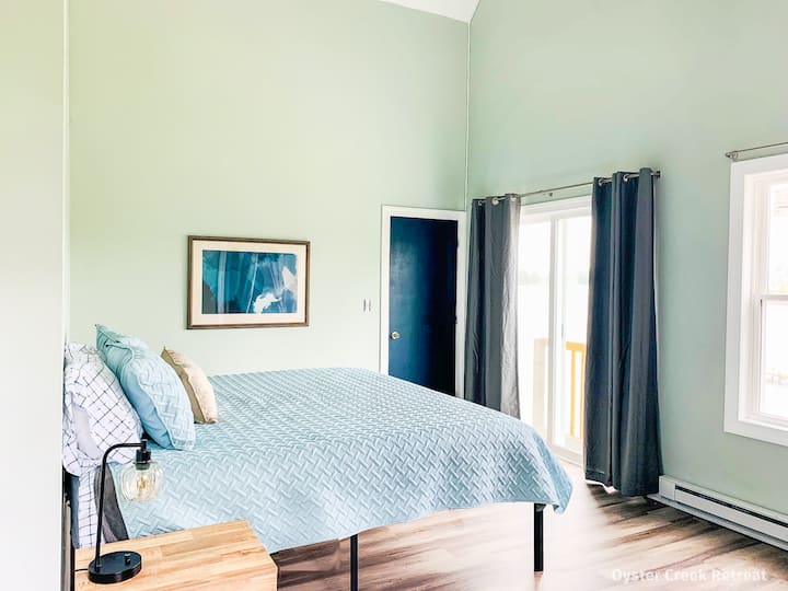 The western bedroom has a balcony overlooking Little Oyster Creek and features amazing views from the king-sized bed.  A comfortable work area is provided with a desk and chair.
