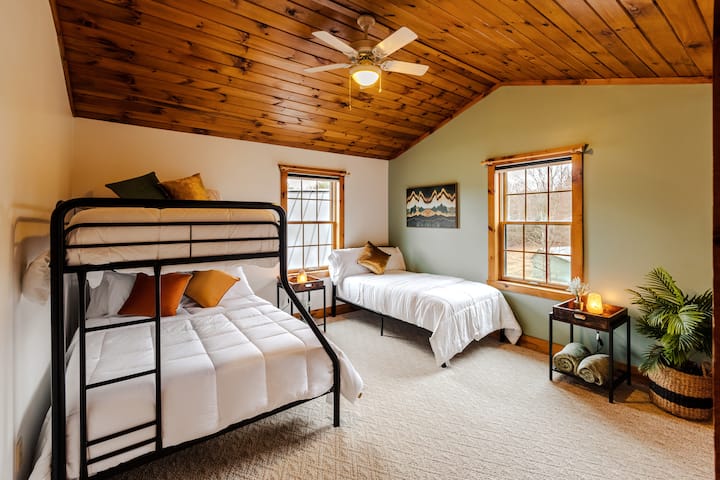 سرير مزدوج بطابقين فوق سرير كامل الحجم.  سرير بطابقين. 

احصل على مكانك. يوفر كل سرير من هذه الأسرّة مرتبة ولحافات فاخرة.