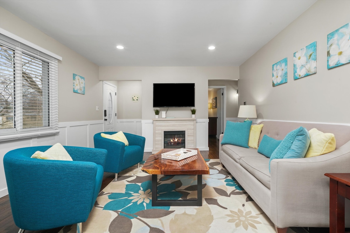 Living Room with pull-out couch, smart TV,  electric fireplace (operates with or without heat), hardwood floors.