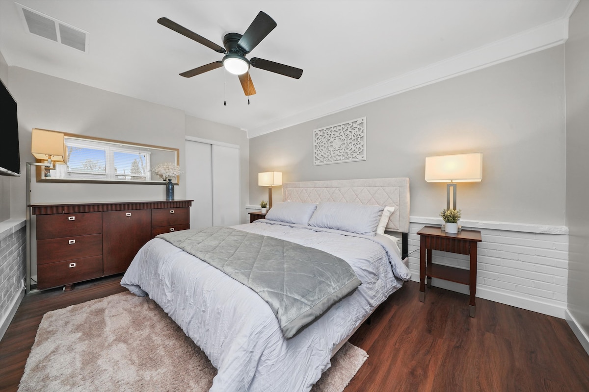 Bedroom - king size bed with comfortable mattress, night stands, dresser, closet, ceiling fan, smart TV, window blinds and mirror.