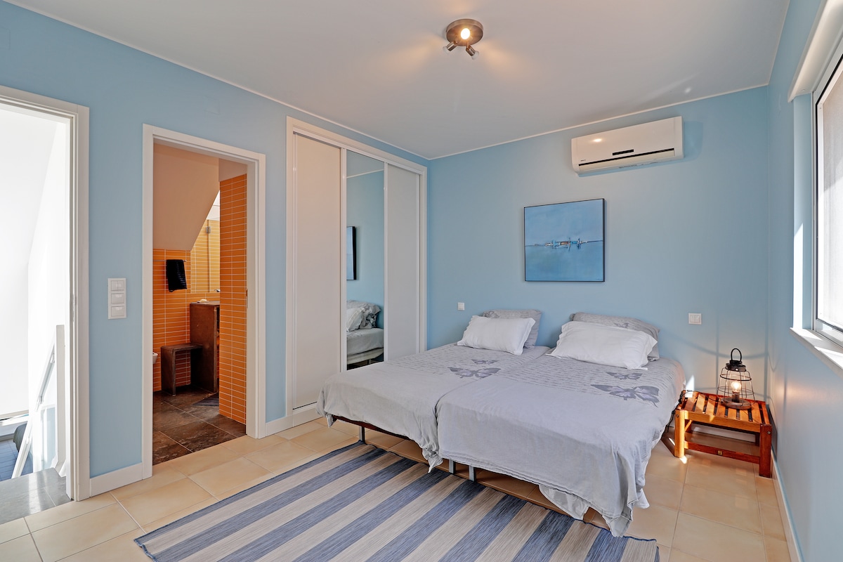 Third bedroom with two single beds, ensuite bathroom, aircon and TV