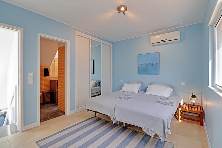 Third bedroom with two single beds, ensuite bathroom, aircon and TV