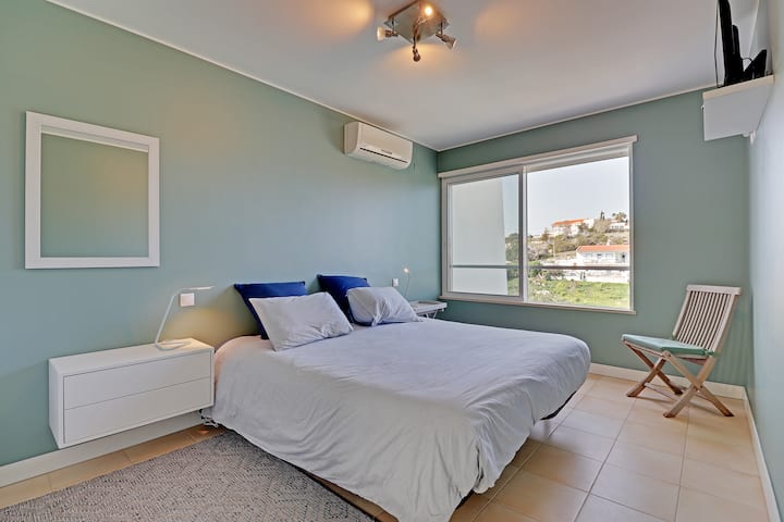 Second bedroom with a double bed, wardrobe, TV and Aircon