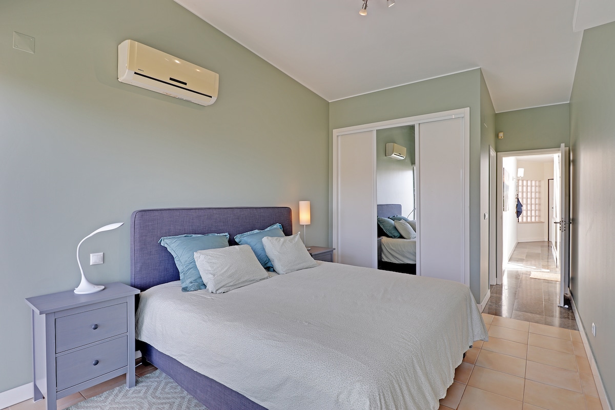 Master bedroom with wardrobe, ensuite bathroom, sliding doors to a private terrace, aircon and TV