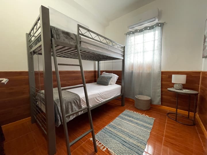 Dhoma e gjumit e dytë me krevate marinari dhe raft valixhesh. 