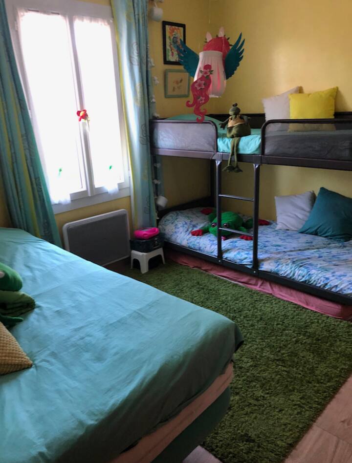 chumba cha watoto kilicho na kitanda kimoja na kitanda cha ghorofa, michezo na vitabu vya watoto 