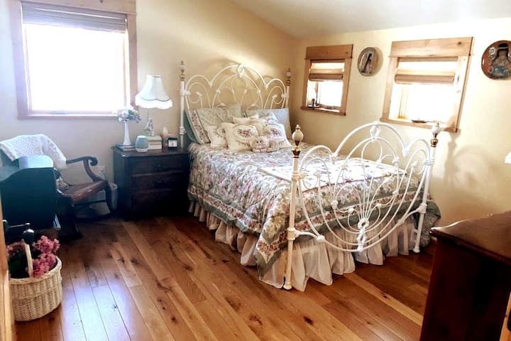 Middle bedroom upstairs with full bed - great views from every window. Closet and dresser storage. Crack open windows at night and hear the creek that runs behind the house.