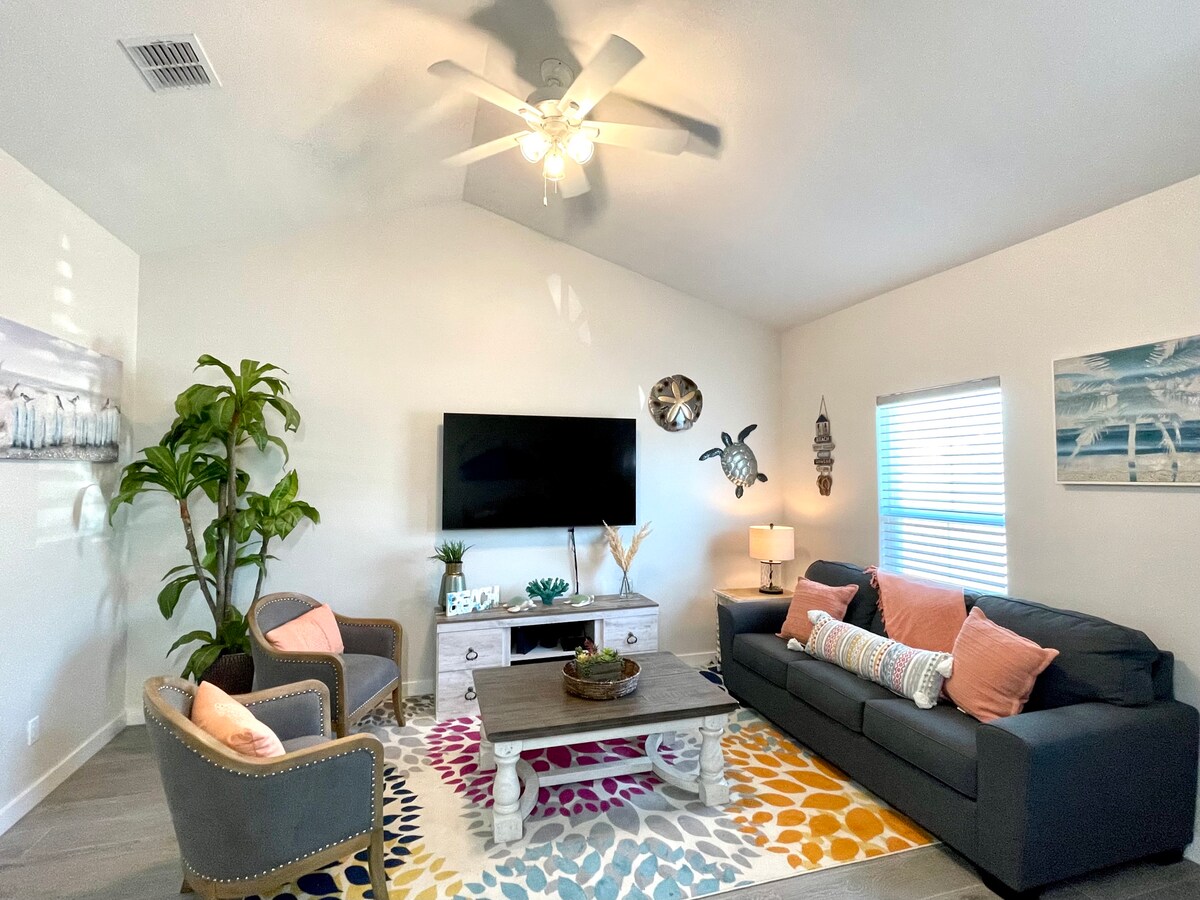 ห้องนั่งเล่นที่สวยงามพร้อมโซฟาปรับนอนขนาดควีนไซส์ทีวีจอแบนขนาดใหญ่และพัดลมเพดาน 