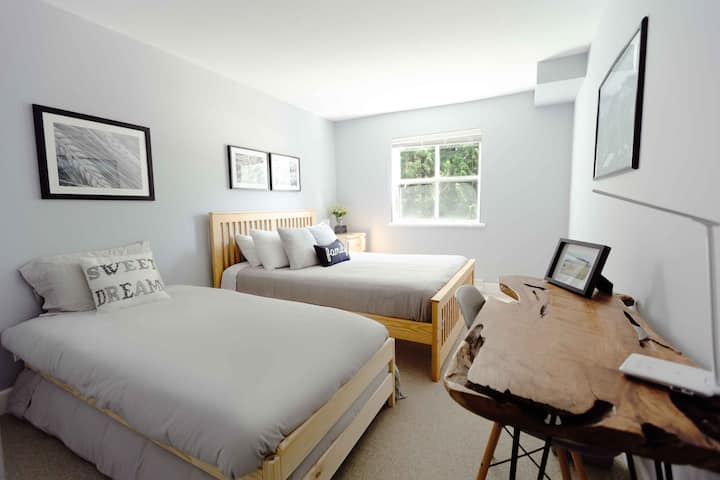 Main floor double bedroom queen bed, 2 twin beds and a workspace