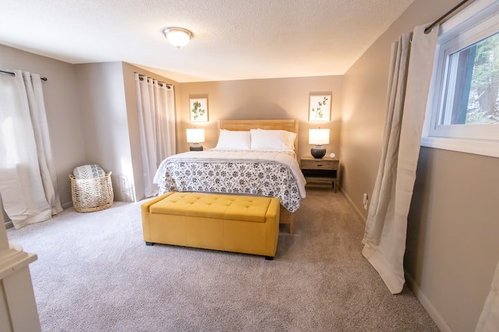 Large main bedroom with queen size bed, large closet with hangers, nightstands/lamps, bench, dresser, chair and floor length mirror. 