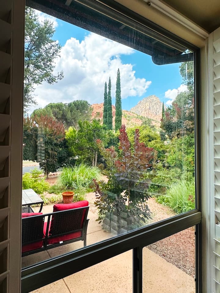 Master bedroom features stunning red rock and mountain views right from the window. Wake up to vibrant desert scenery, lush landscaping, and peaceful outdoor seating—creating a calming, picturesque start to every Sedona morning.