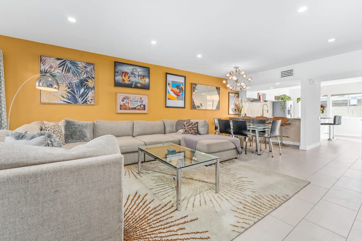 Large living room that extends into the kitchen to create one space where everyone can hangout, cook, and watch TV. 