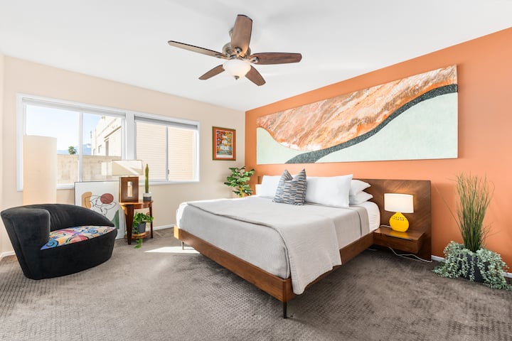 The recently redesigned main bedroom features ample natural light, a king-sized Purple Hybrid Premier 4 mattress, a reading nook, and  a custom art piece from a local artist.  A second desk is also occasionally available in this room, not pictured. 