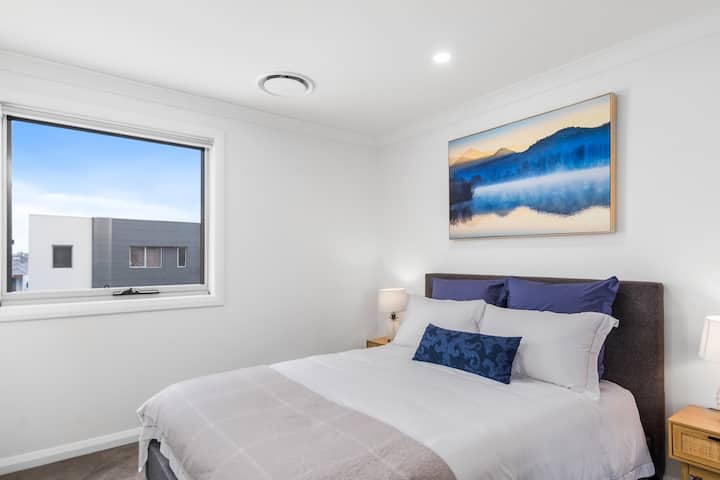 The third bedroom, located upstairs, offers a queen-size bed and mirrored built-in robes.
