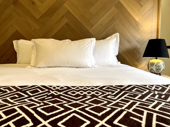 Kitanda cha ukubwa wa mfalme chenye godoro zuri sana. Chumba kizuri chenye dari yenye urefu maradufu.