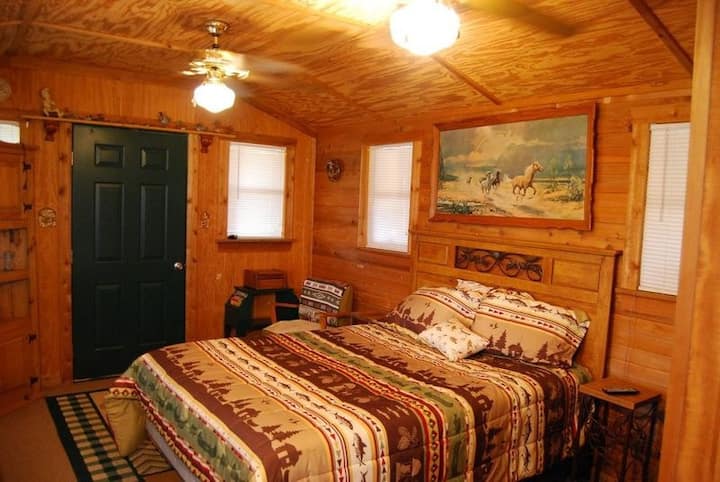Cabin 2 has a queen size bed along with a oversized sleep chair has tv and a land line the front door leads to patio front porch back door leads to breeze way side door to coved area between cabin 2 and 3 