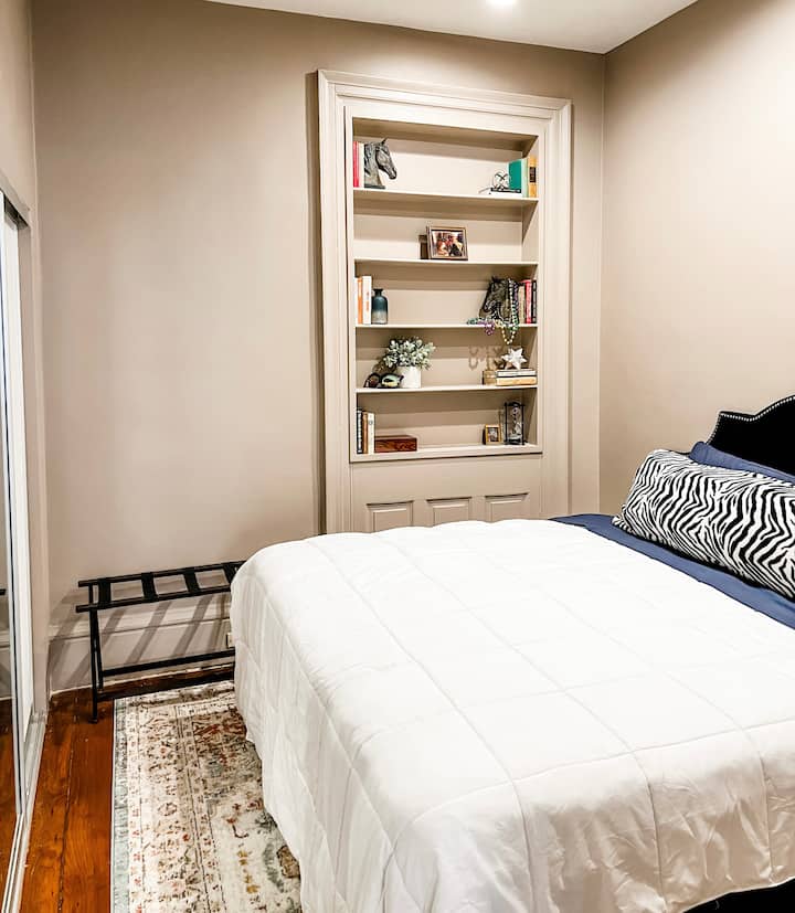 Sleep in style! Relax in this cozy queen bed surrounded by wall displays & well-lit room. Wake up refreshed & ready for your next adventure! #cozyvibes
