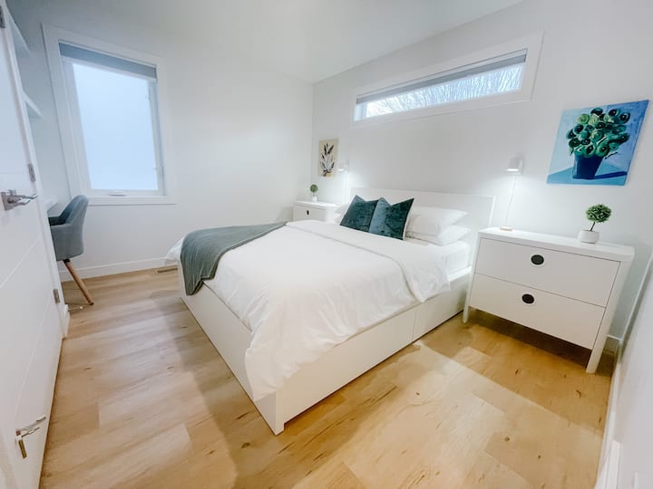 Queen size bed with made in Canada Haven Sleep Co. LUX Hybrid Pillowtop mattress.   Blackout Cordless Cellular shades on both windows. 