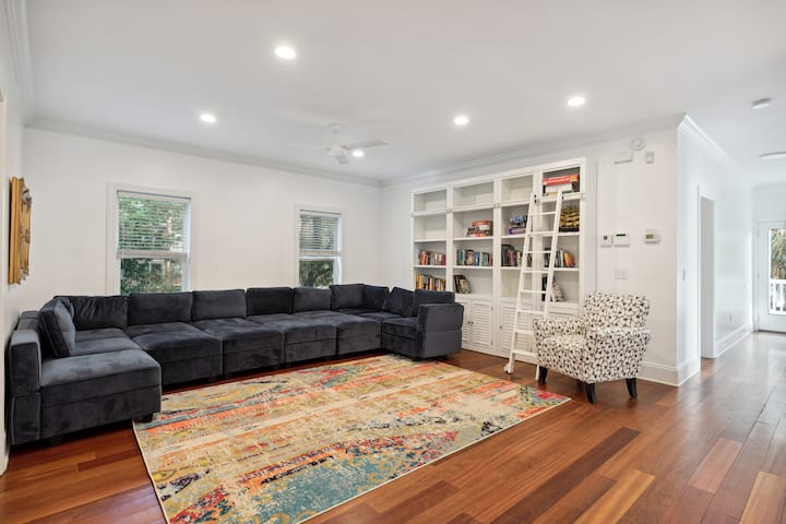The room is a spacious and comfortable area that features a couch that easily converts into two beds, providing ample sleeping space for guests. A large TV mounted on the wall provides a perfect place to catch up on your favorite movies or TV shows.