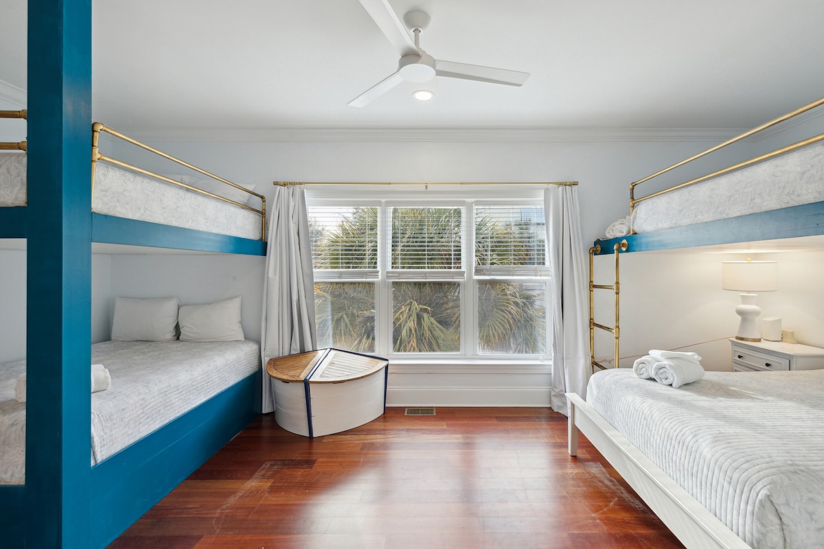 The bunk room is a cozy and comfortable space that features a large window with curtains. The window provides plenty of natural light. The curtains can be drawn closed for privacy or to block out the sunlight when needed.