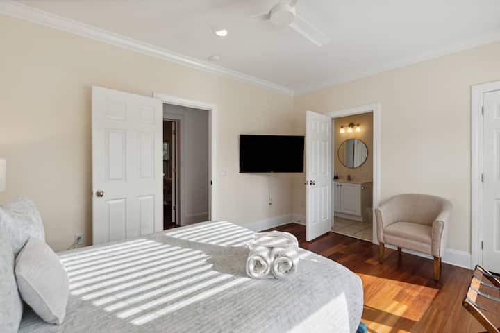 large tv and entrance to bathroom