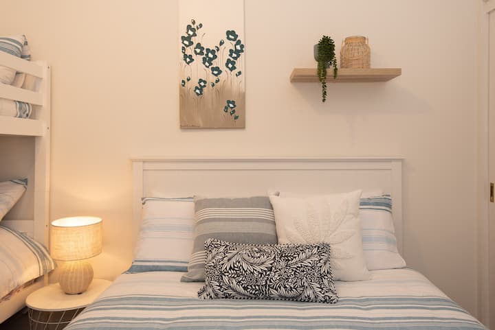 Second bedroom with comfortable Queen bed and bunk bed (two singles). Also portacot available in the cupboard. 
