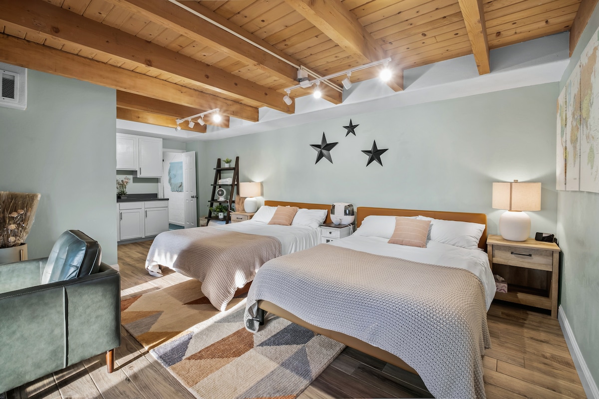 Bedroom #4 - Downstairs bedroom with 2 queen beds (Zinus memory foam). 3 nightstands, ample outlets. HomePod Mini, and humidifier. And that pop of Northstar with the tri-star wall decoration. 