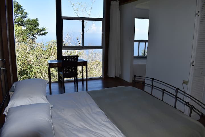 Dormitorio con vistas a la luz desde el océano en un día despejado.