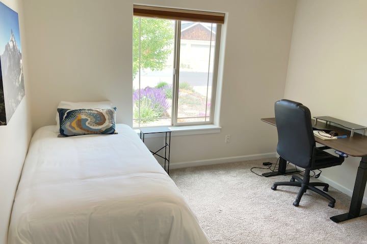 [Bedroom/Office] Third bedroom has a twin bed, dresser, closet with hangers and dedicated office workspace with electric adjustable sitting/standing desk, office chair and surge protector for your days working remotely!