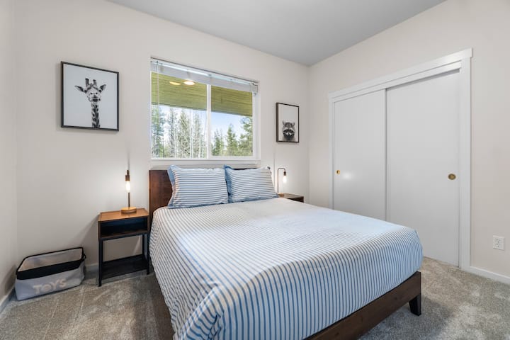 Second bedroom with a queen size bed and views of the front of the house