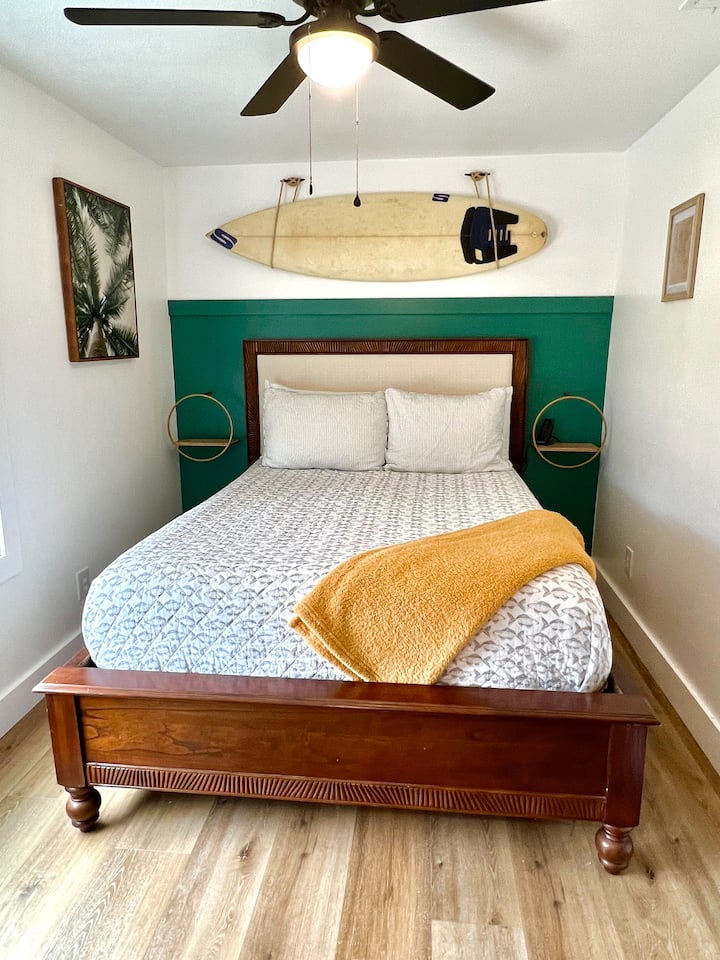 Main level bedroom complete with cozy queen bed. This room features a, dresser, armoire and views of the front yard from window.