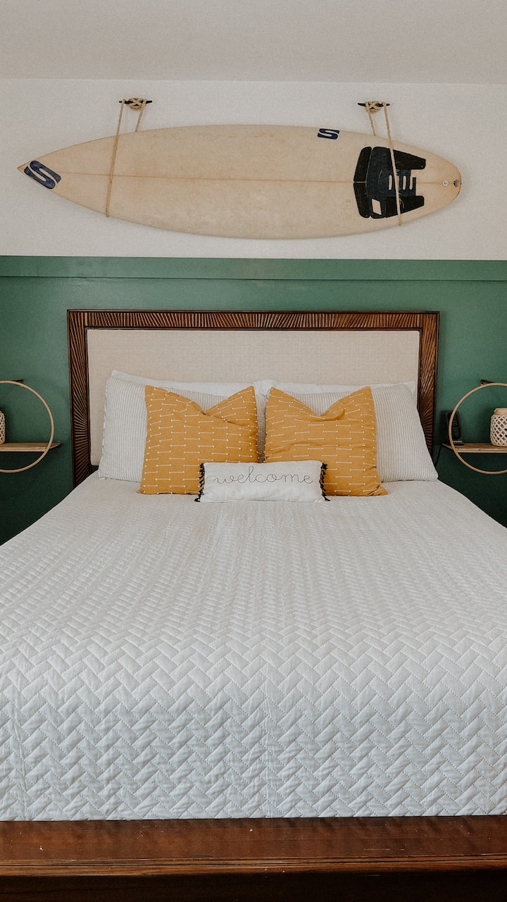 Surfboard room with queen bed.