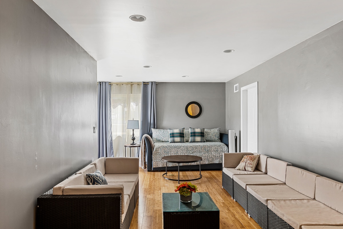 Sala de juegos con zona de estar y cama de día con cama de dos camas individuales. 