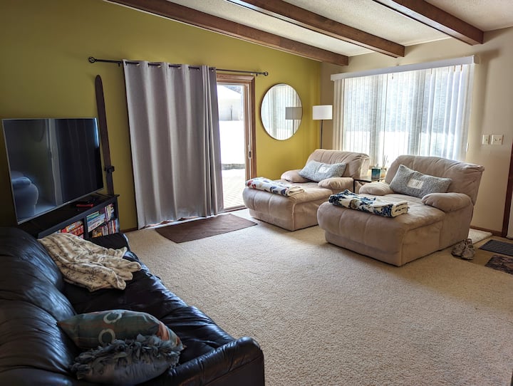 Main floor family room gathering space with 65" TV