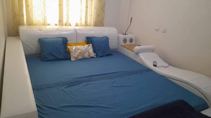 King size bedroom with massage features, reading lamp, and blue tooth sound system. 