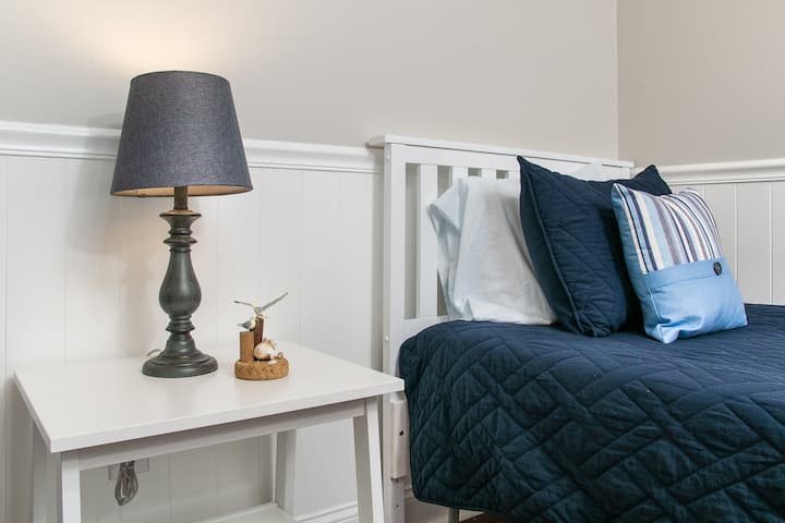 Side of twin bed, ready for a comfortable night sleep.
