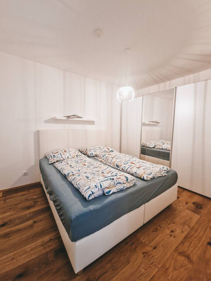 Large box spring bed in the bedroom