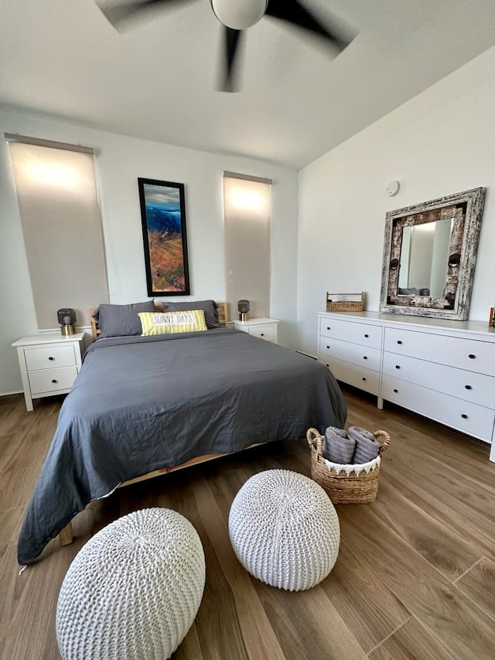 Main bedroom: Fan, AC inverter unit, 55" SMART TV, six drawers, mirror, queen-size bed, and one chair.
