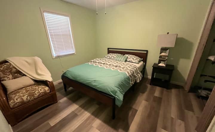 Queen bedroom with cozy chair