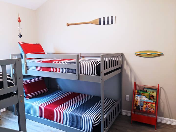 Third bedroom with lots of toys and books for kids.